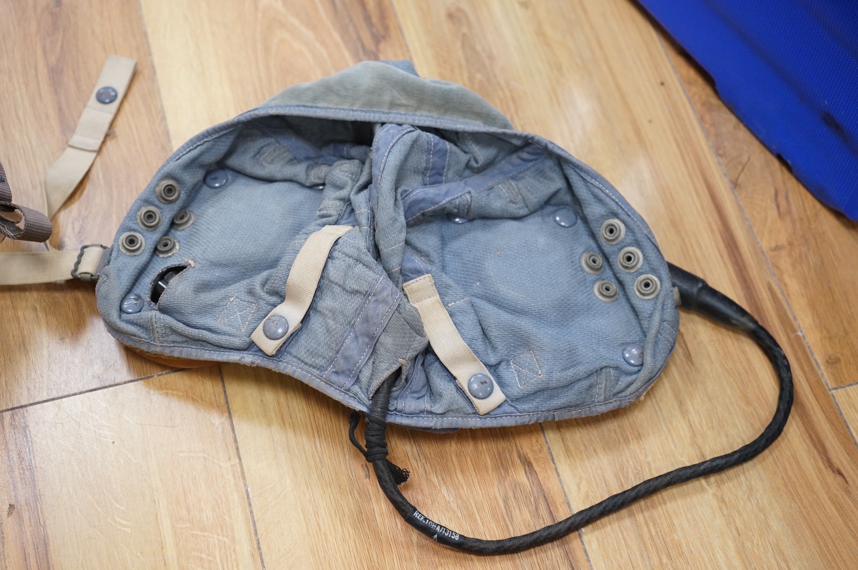 An early British jet aircraft RAF flying helmet, size 3 regular, dated 1958, with visor and visor cover, and original interior webbing, complete with inner cloth flight cap with built-in headphones and electrics and date
